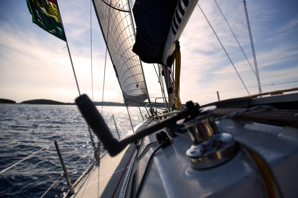 Minimalist sailboat on open water — a symbol of clarity, direction, and calm leadership.