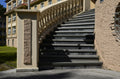 a wide stone staircase inside an old castle, softly lit by natural light from above. the worn steps curve gently upward, creating a quiet sense of depth and history. shadows rest along the walls, giving the scene a calm, timeless atmosphere. the staircase feels like an inner passage, inviting the viewer to rise slowly toward clarity and a more spacious inner place.
