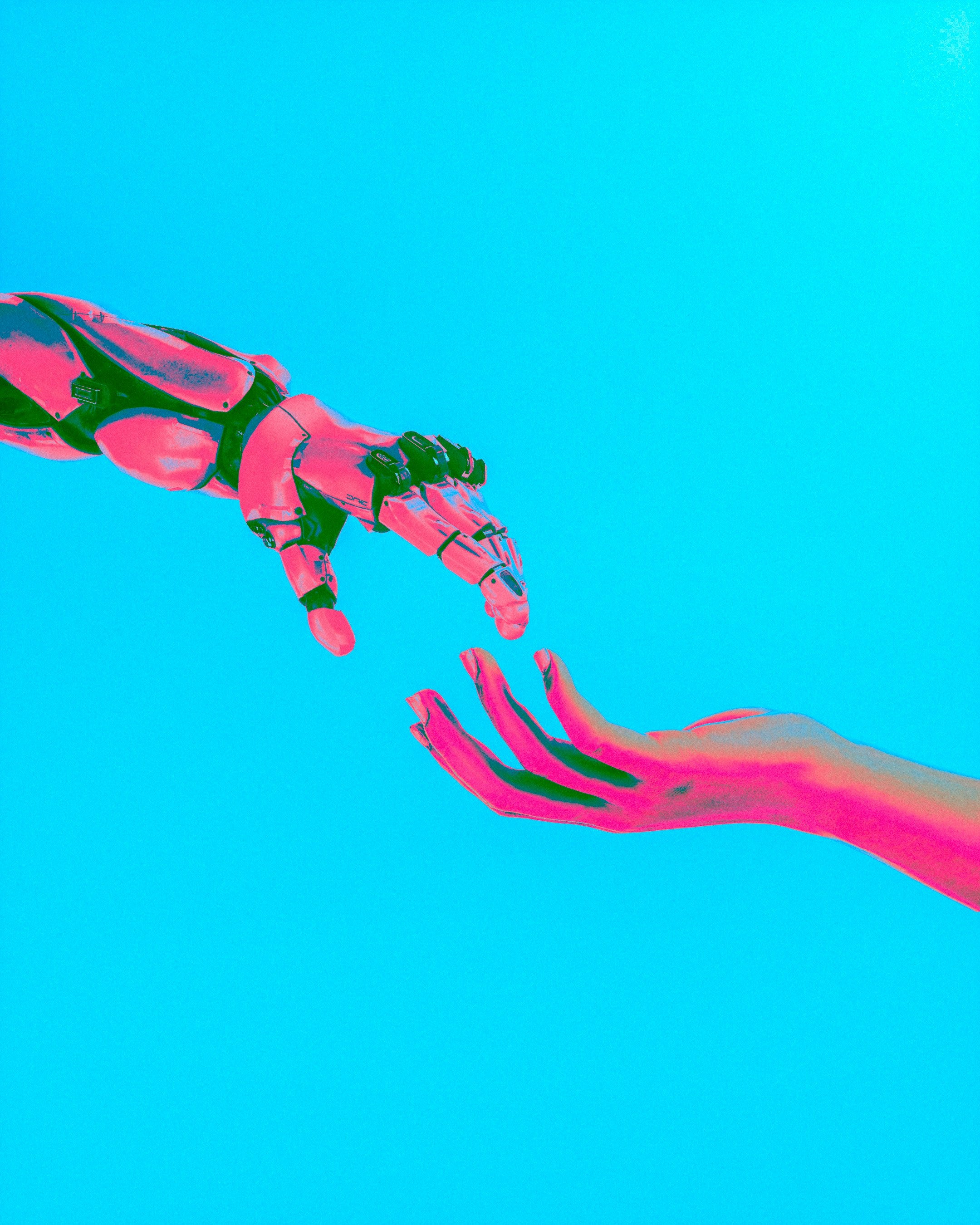 a robotic hand reaching gently toward a woman’s hand, both suspended in soft light like a modern echo of the sistine chapel — a calm symbol of human‑ai collaboration, shared awareness and the subtle atmosphere of vibeleadership