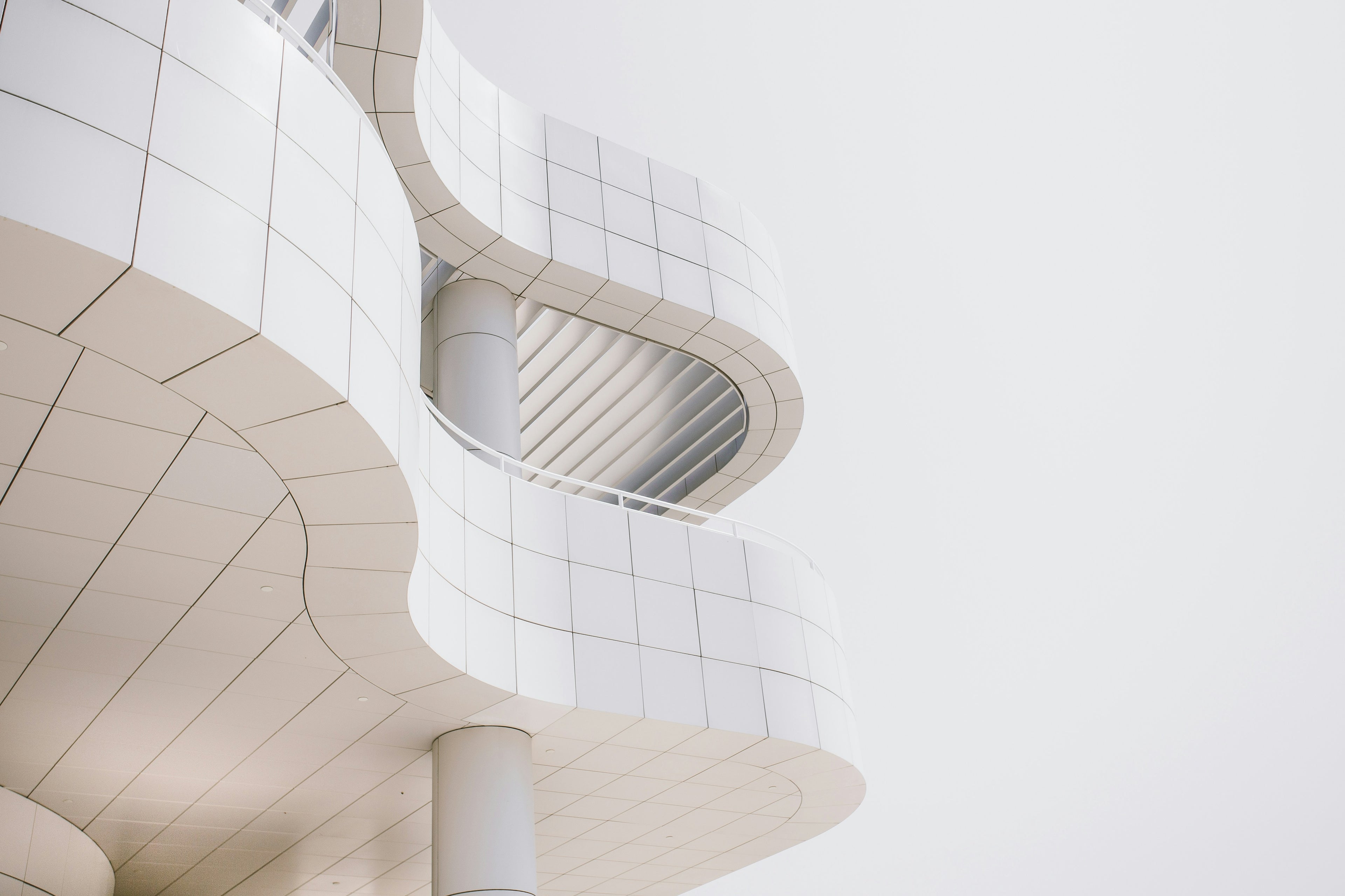 a modern architectural space with curved white surfaces resting on a solid foundation.
the image carries a sense of clarity and calm strength.