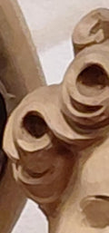 a close‑up of a carved wooden curl, soft and luminous, symbolizing quiet authority and gentle leadership — a reminder of strength expressed through tenderness and presence.
